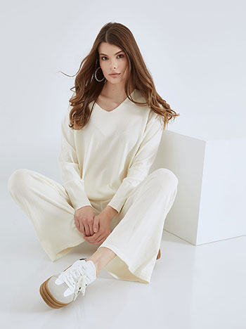 Knitted sweater and trousers set in off white