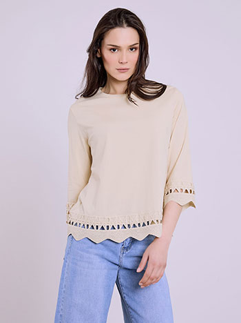 Top with embroidered hemline in beige