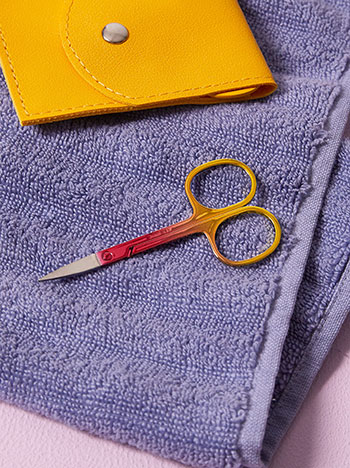 Metallic nail scissors in yellow red