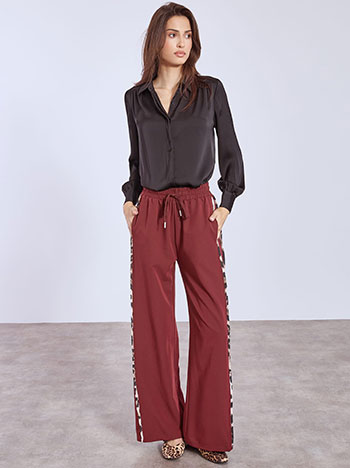 Wide leg trousers with animal print stripes in wine red